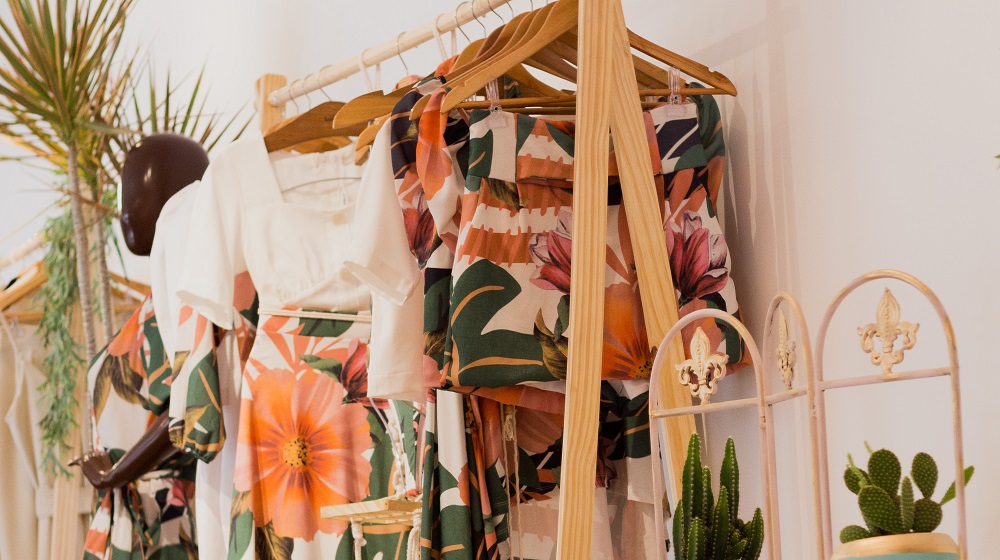 clothes hanging on a wooden rack