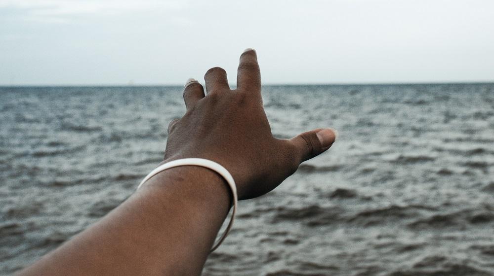 Person reaching towards the skyline