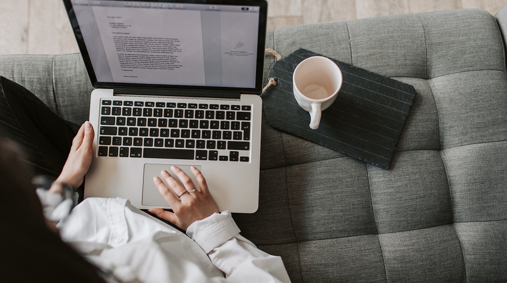 Woman using laptop on sofa