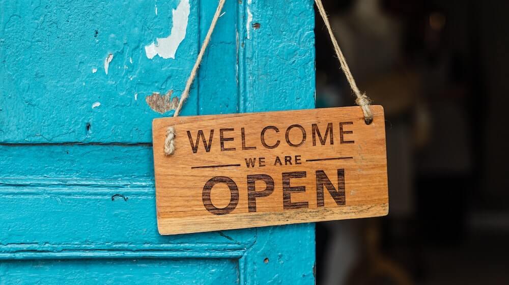 welcome sign on teal door