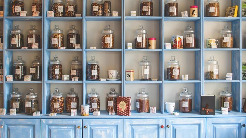 Apothecary jars on a blue set of shelves