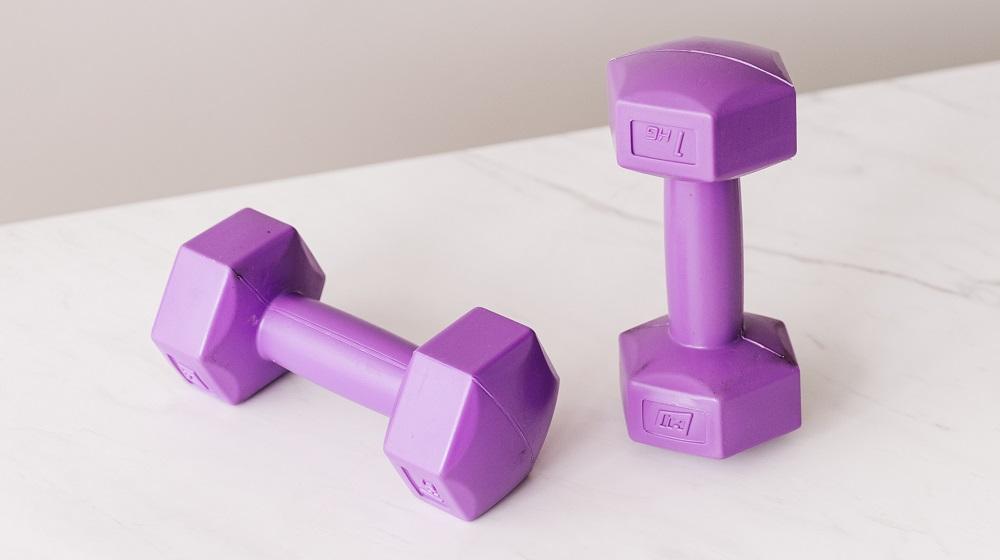 Two purple dumbbells on a table