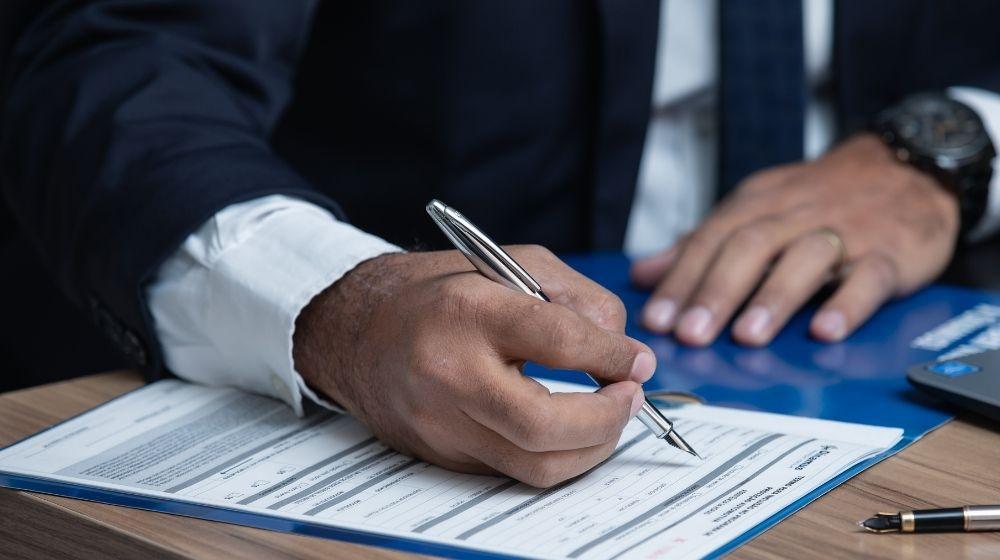 Trademark Domain Name Man Signing Paperwork