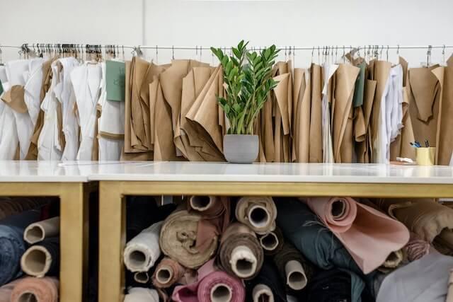 Rolls of frabric with prototype clothing in background