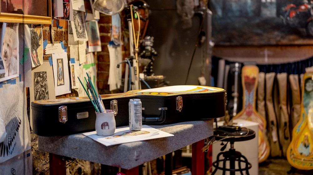 Guitar case resting on a work table in a studio