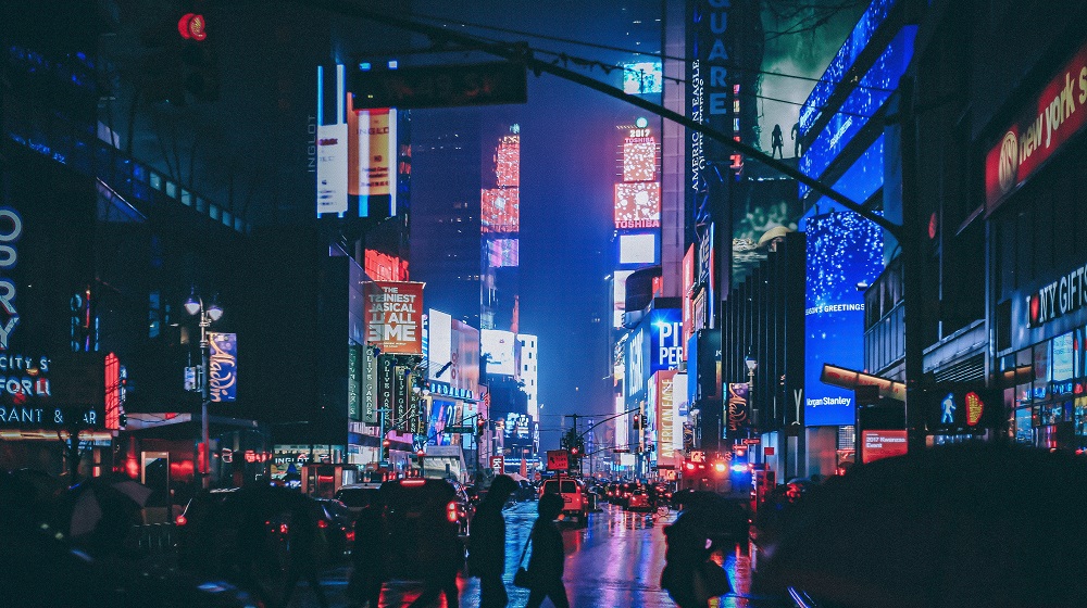 Times Square in New York City at night with brightly-lit advertisements