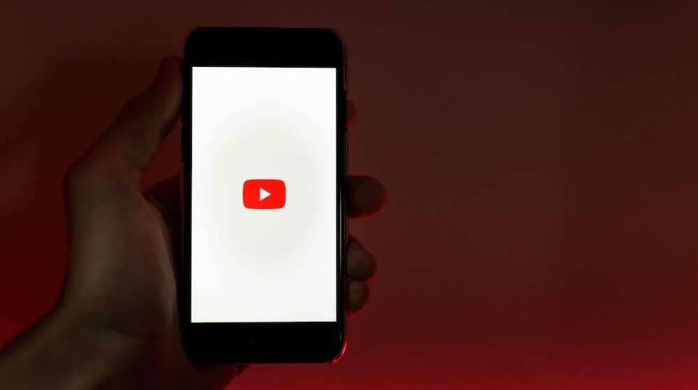 YouTube on phone with red background