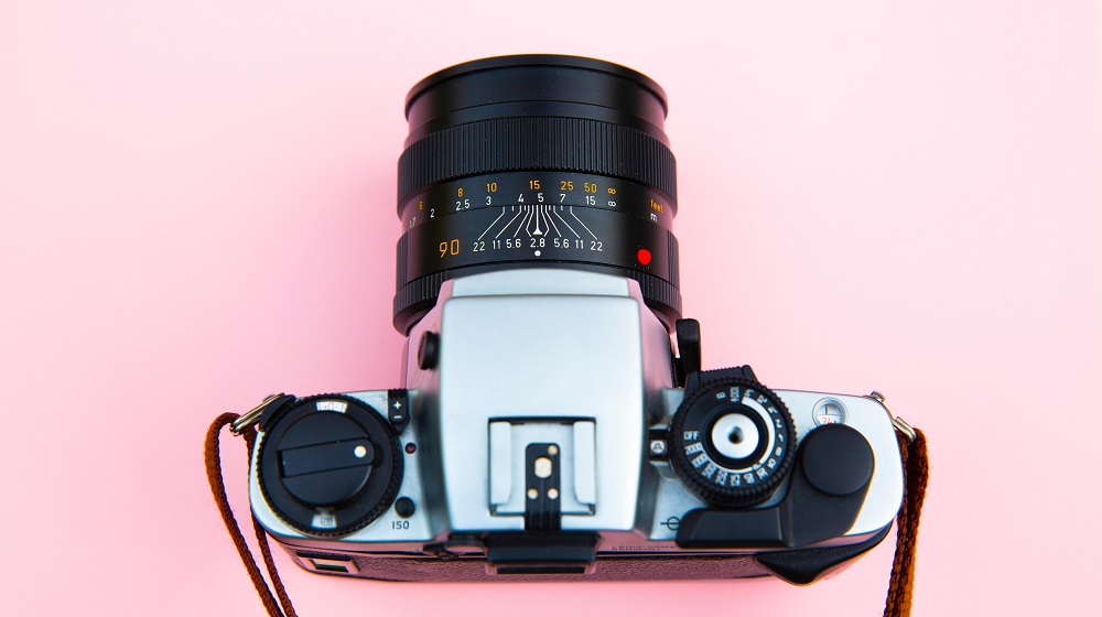 Camera sitting on a pink background