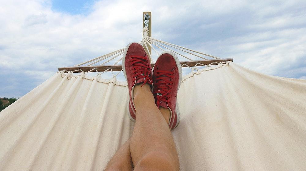 Person reclining on a hammock