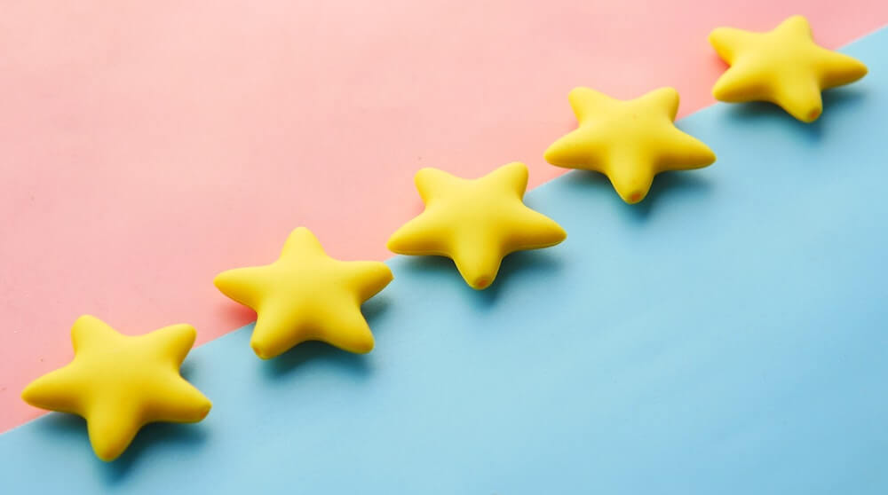 5 yellow stars on pink and blue background