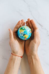 Close-up of hands holding a miniature globe