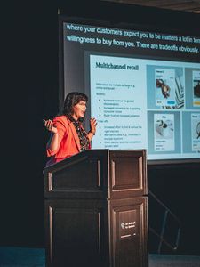 Beka Rice standing at podium and speaking to audience-2