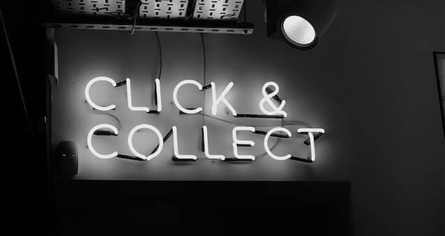Black and white photo of neon sign that reads click & collect
