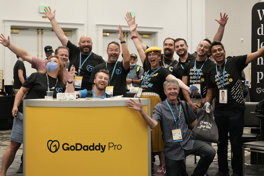 GoDaddy Pro team posing and having fun at the sponsor booth