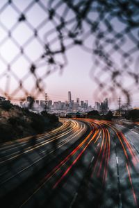 Highway car lights with cityscape in background