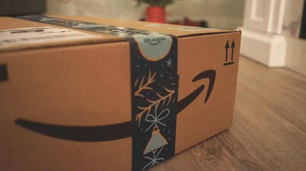 Amazon box on floor near christmas tree