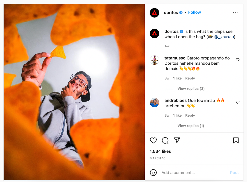 Doritos Instagram post image from the perspective of the chips, looking up at a man holding a chip