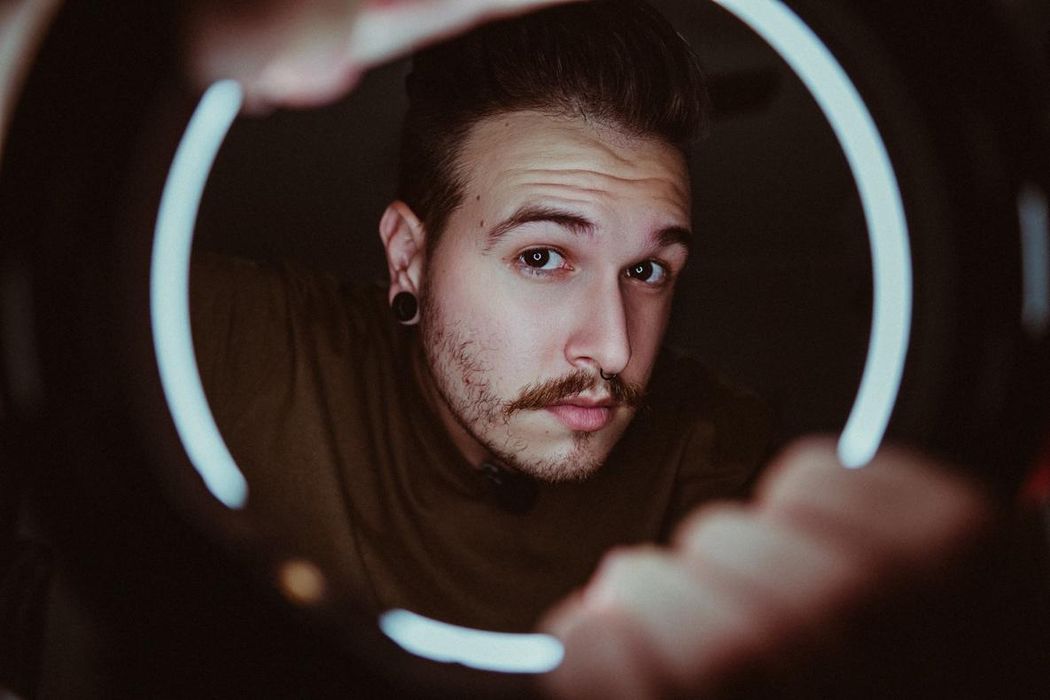 Man looking through a ring light