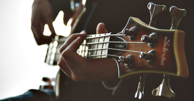 Person playing a bass guitar