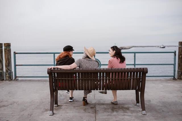 Group of women sitting on a park bench(1)