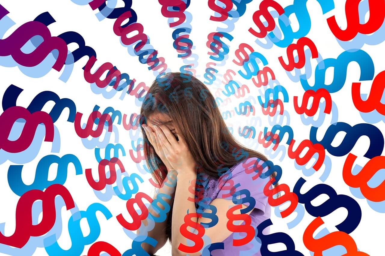 Overwhelmed woman with face in hands (1)