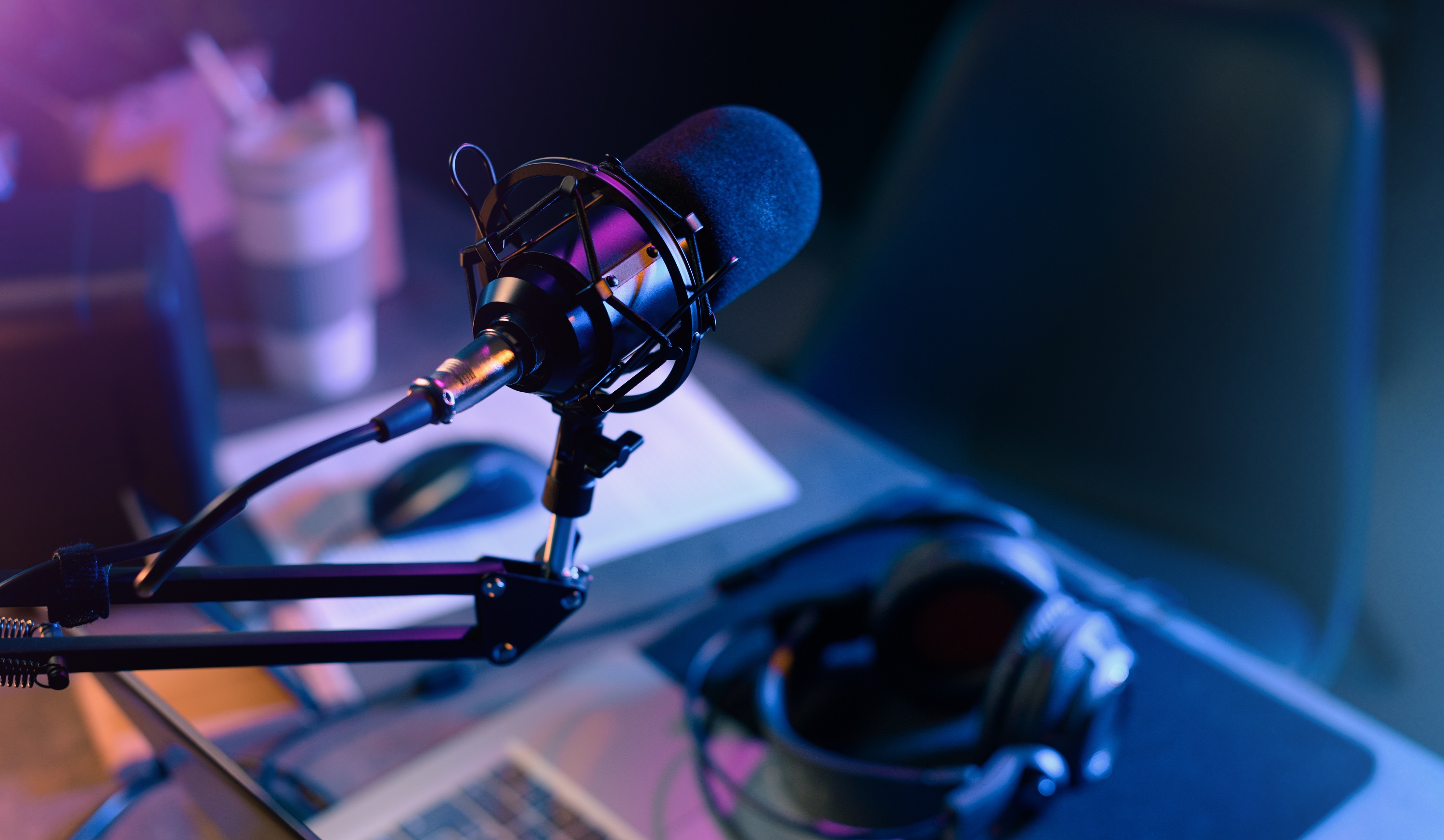 Online live radio studio desk with microphone in the foreground, entertainment and communication concept