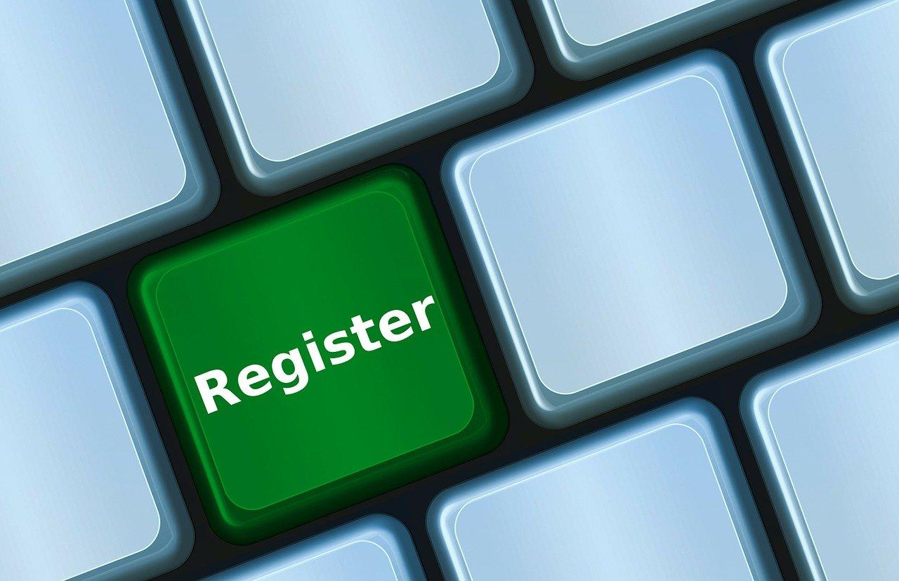 This image shows a computer keyboard with a green key labeled "Register." It stands out among the other keys, which are gray, signifying a call-to-action for registering or signing up for something.