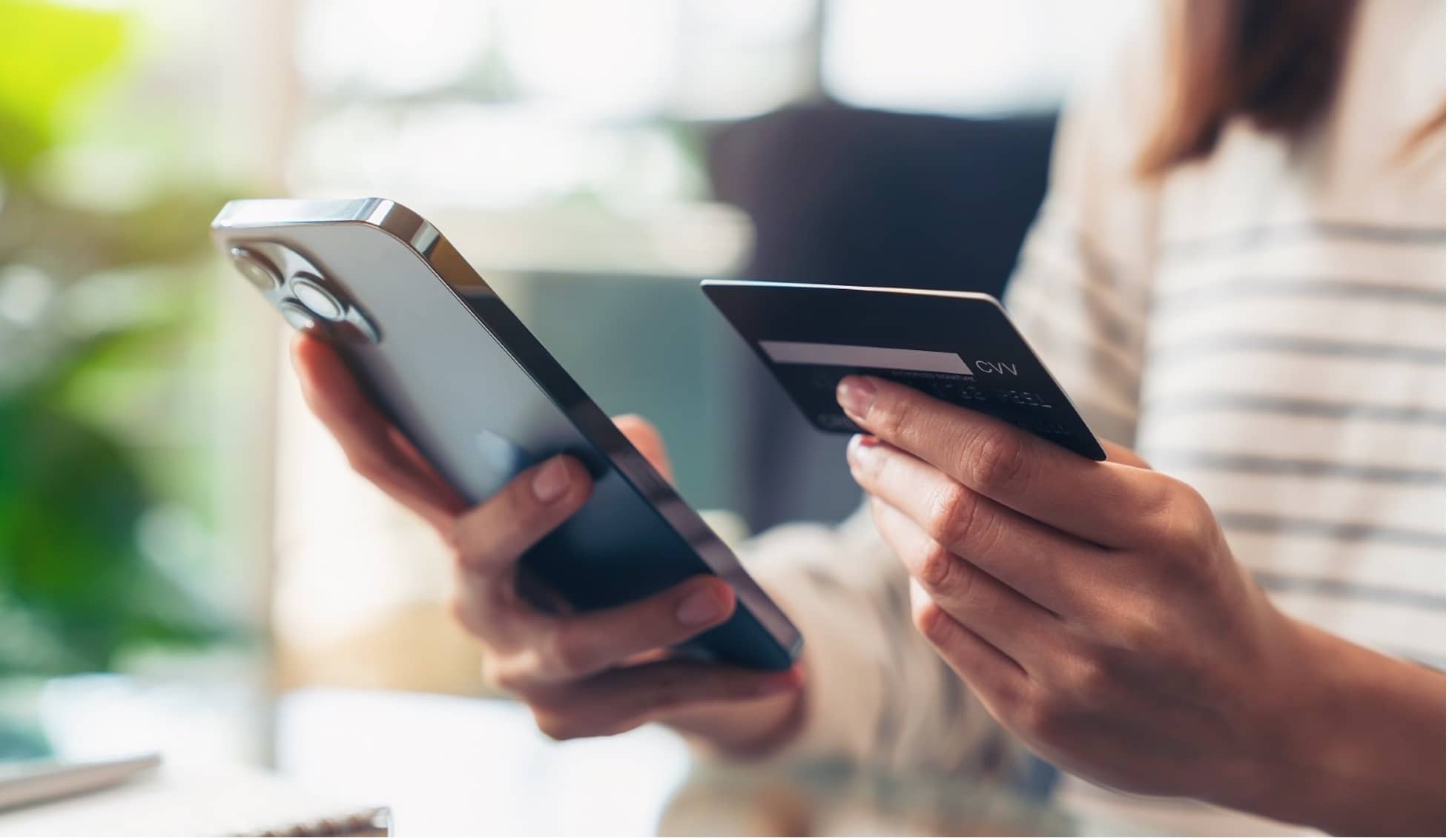 a person using a card to make contactless payment on a mobile device