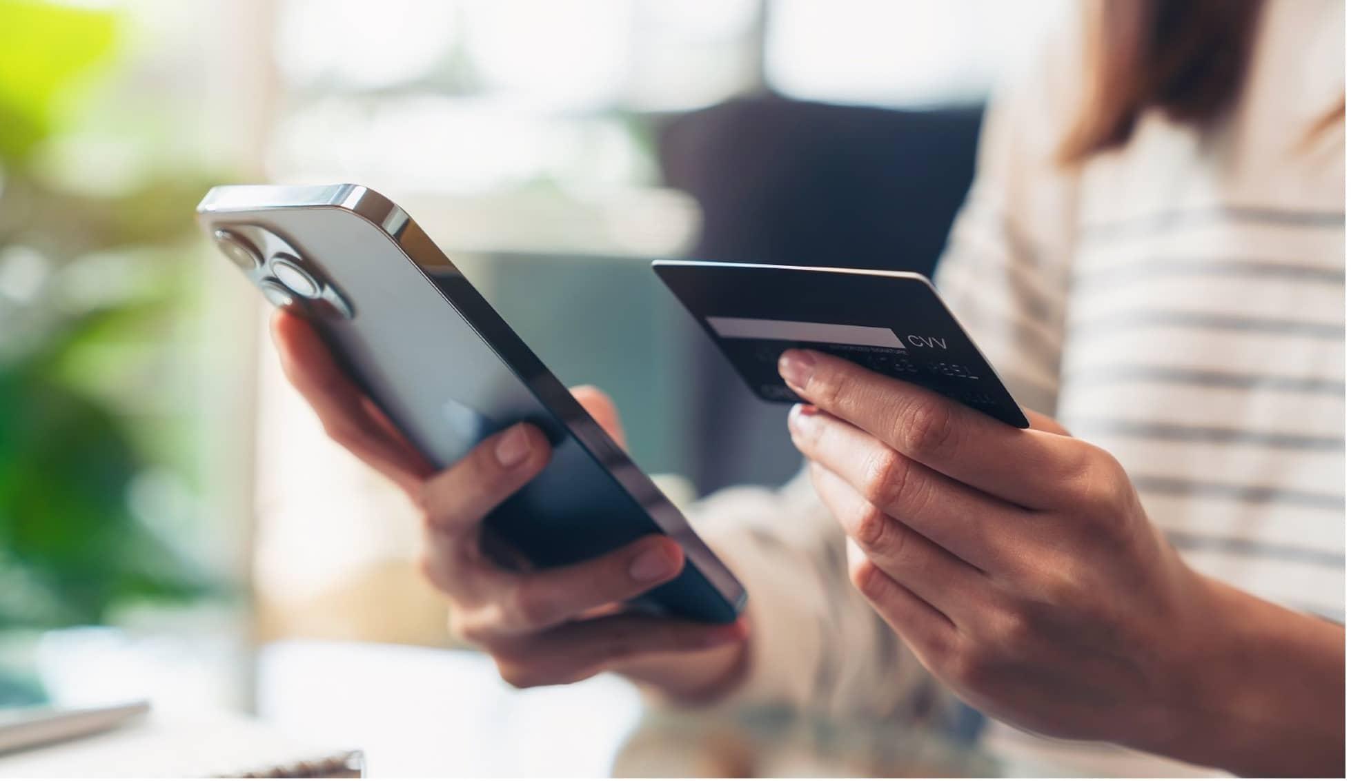 a person using a card to make contactless payment on a mobile device