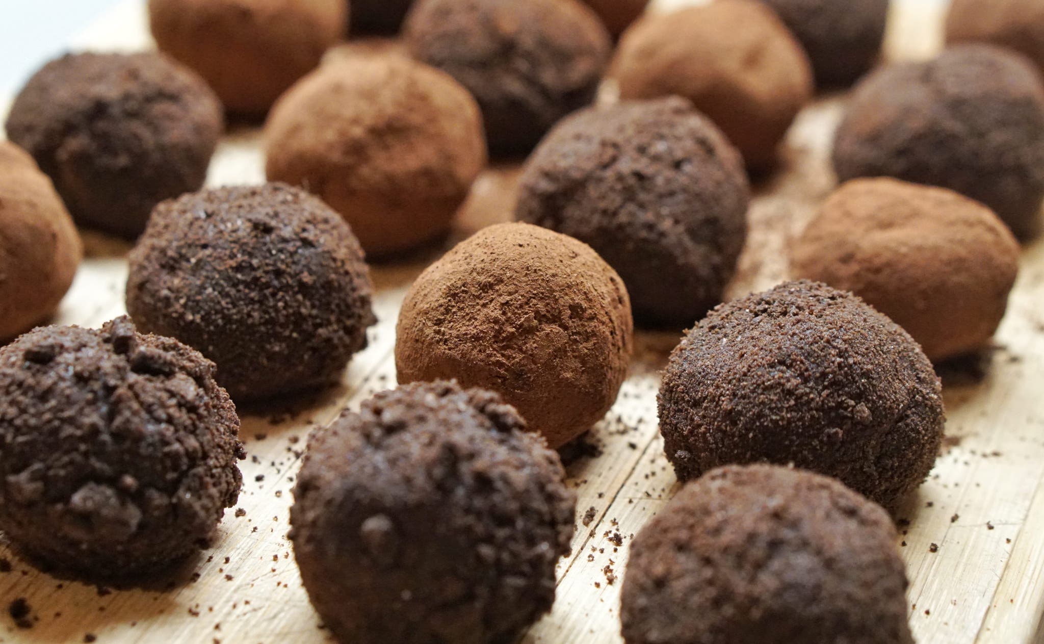 A collection of cookies, round in shape and featuring a combination of brown and black hues