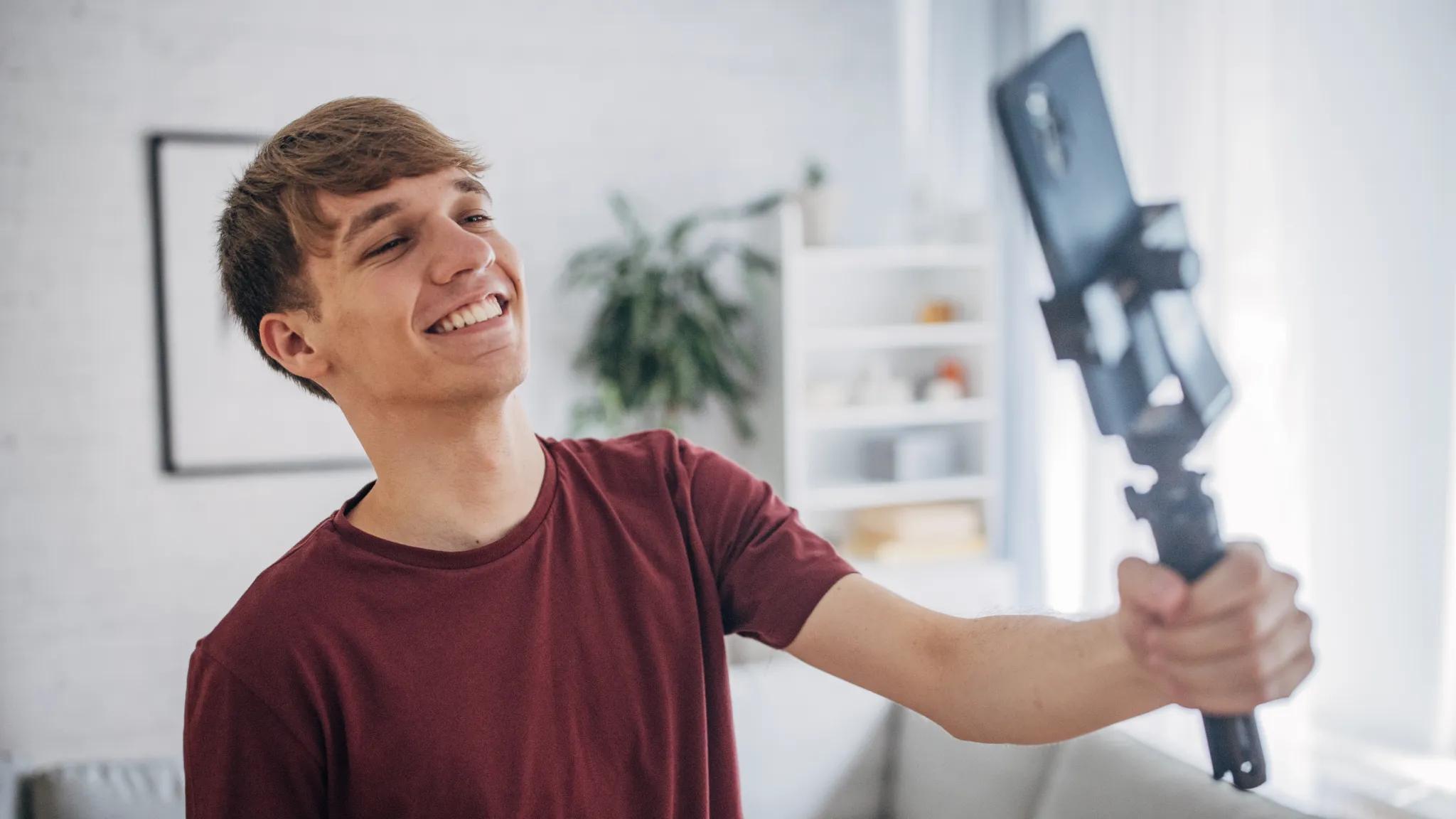 Man holding a selfie stick with a smartphone attached
