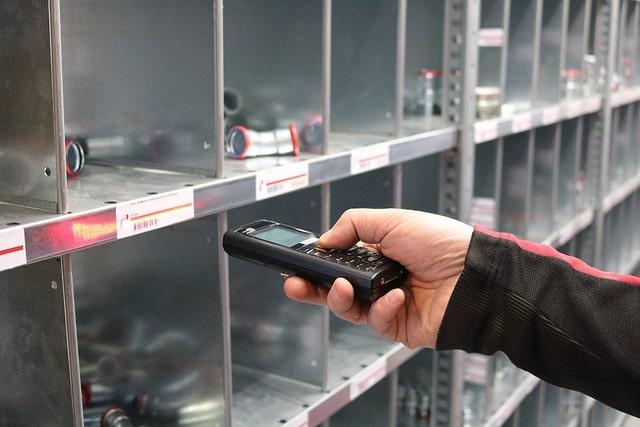 Catalog Management Man Scanning Barcode In Warehouse