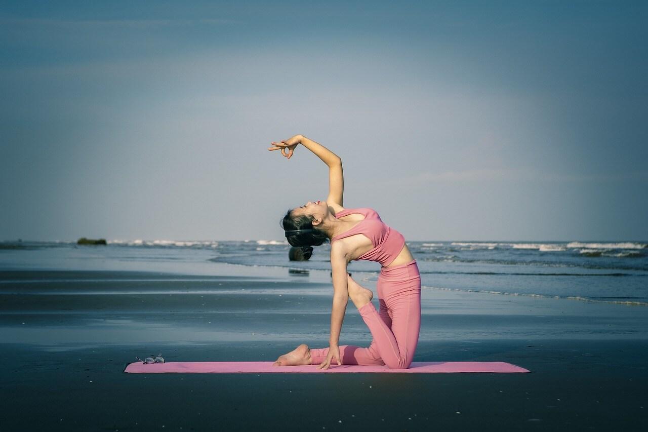 A Woman Practices Yoga on a Beach