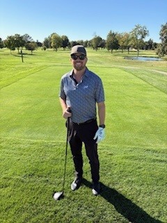 a man standing on a golf course