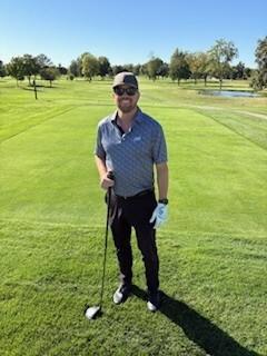 a man standing on a golf course