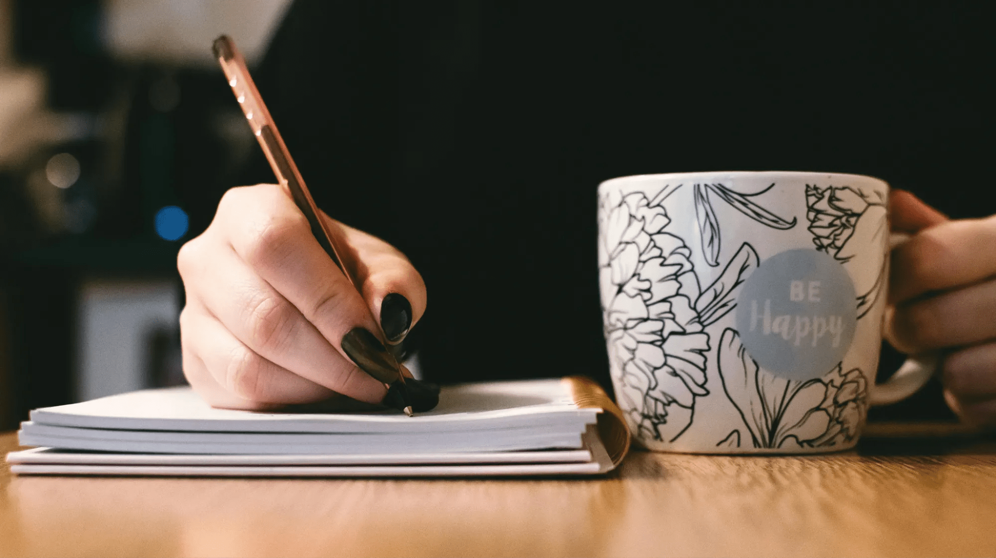 A Close-in Shot of a Hand Writing with a Pen on a Notebook