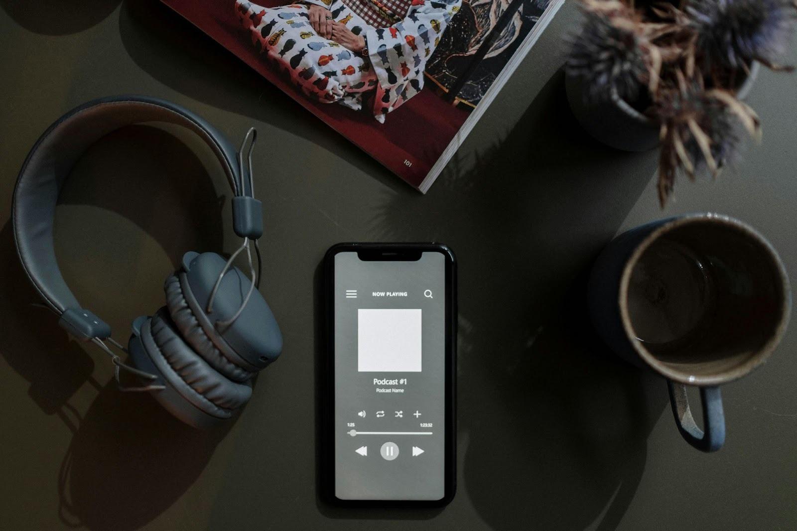 An Overhead Shot of a Mobile Device Suggests Listening to a Podcast