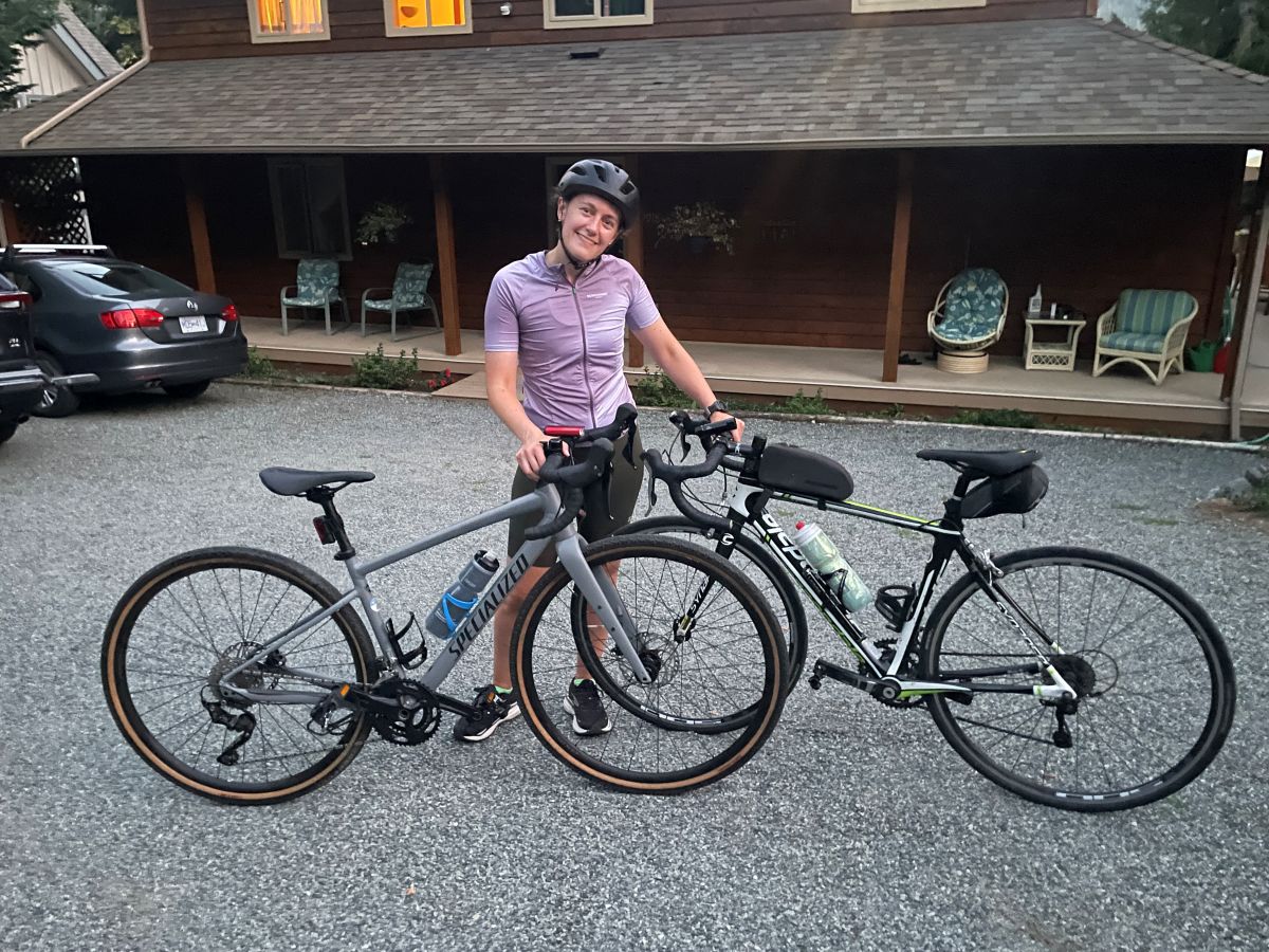 a person standing next to two bikes