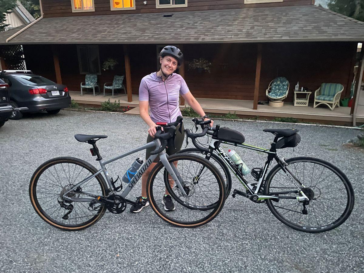 a person standing next to two bikes