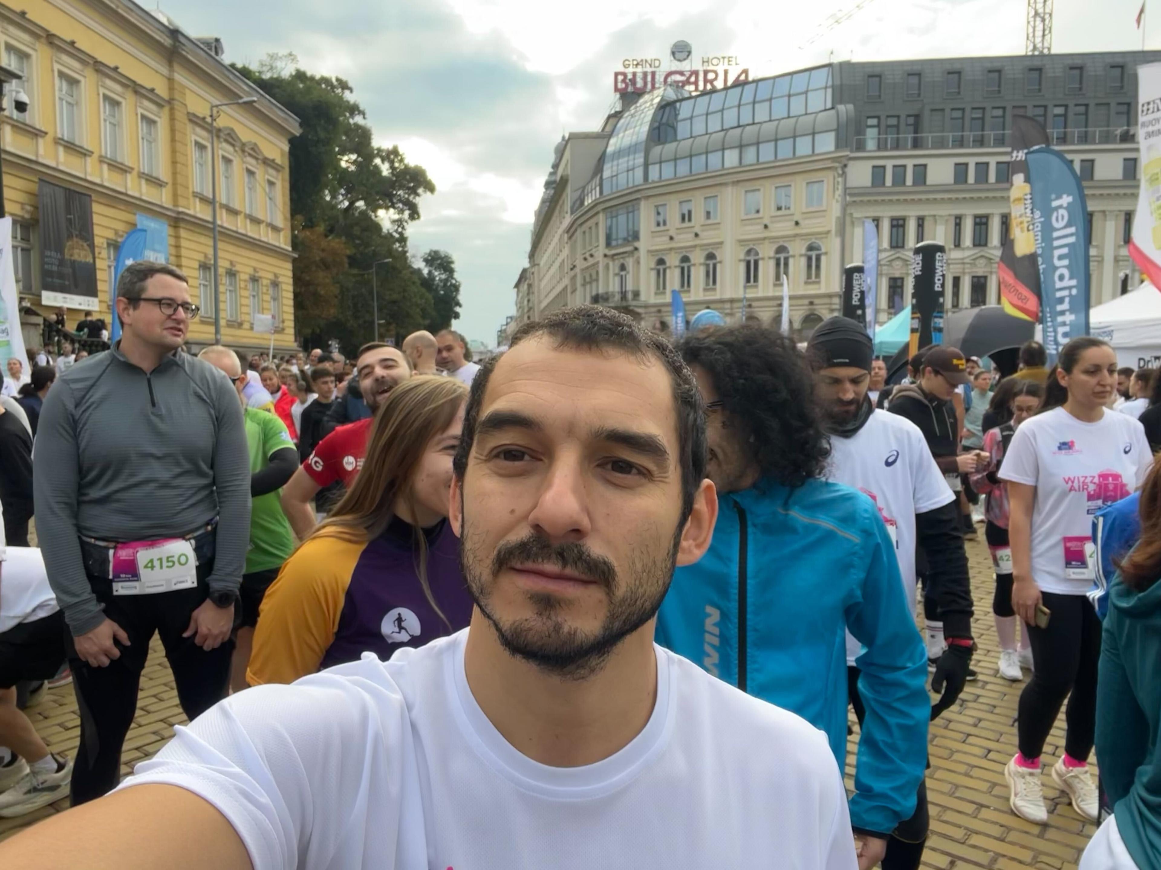 a man taking a selfie in a crowd of people