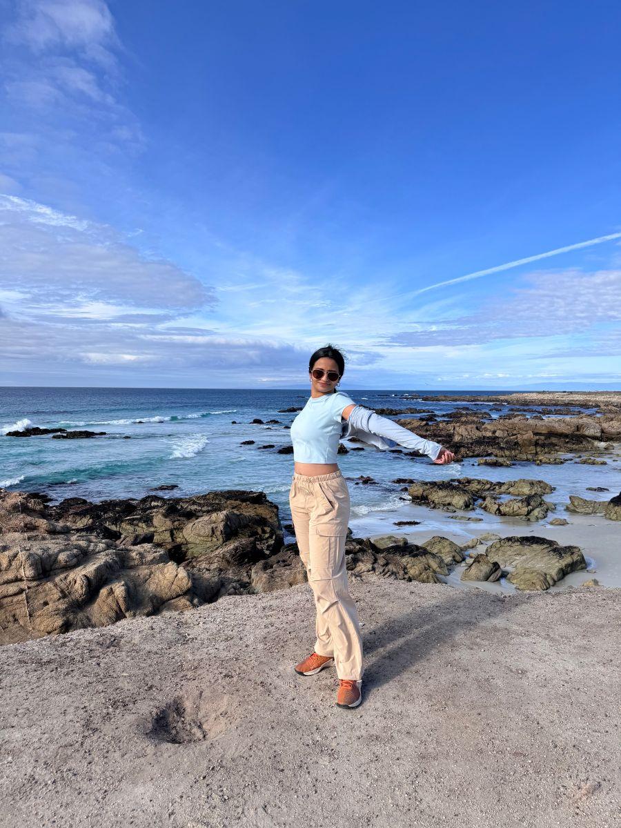a man standing on a rocky beach