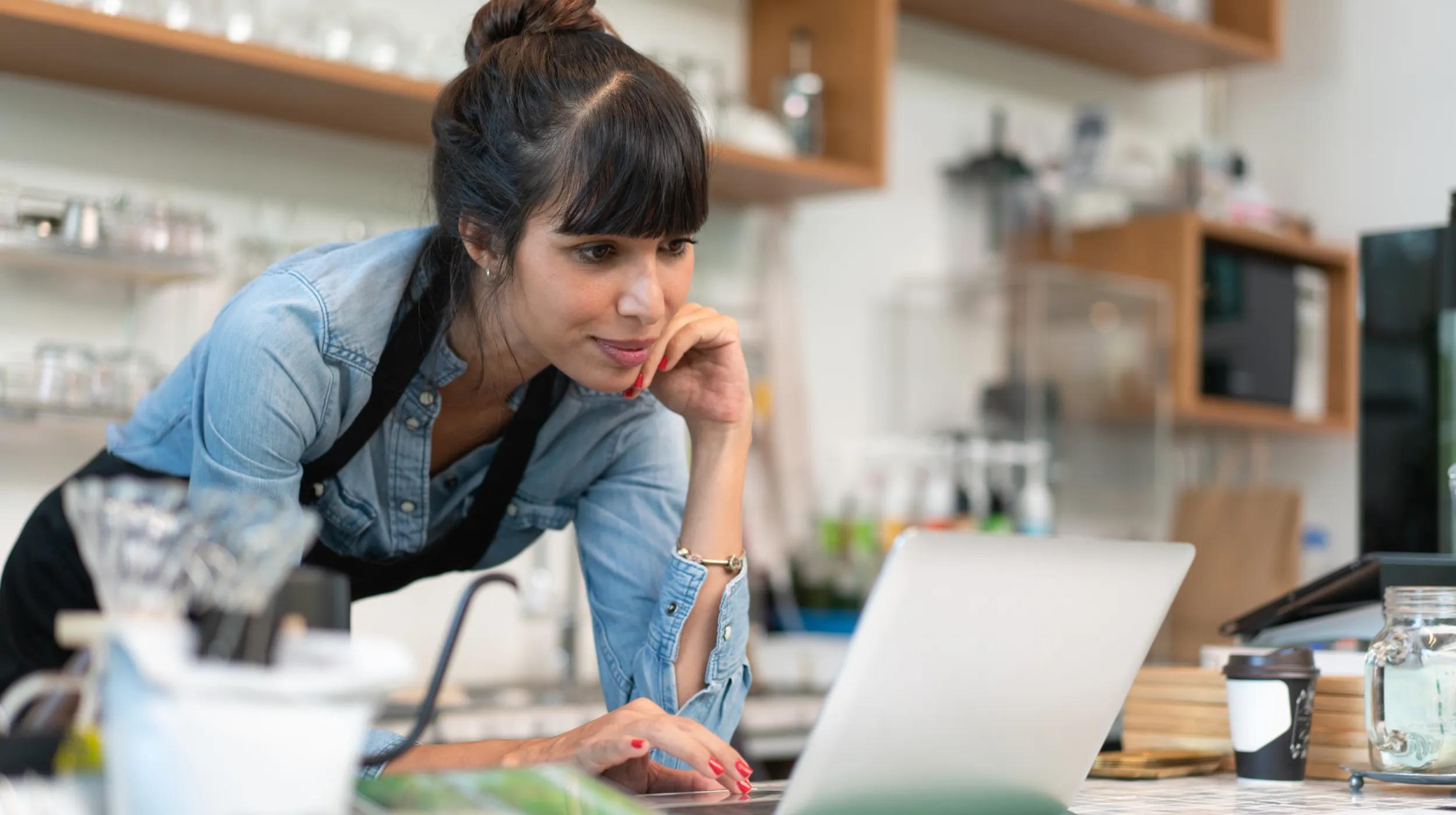 a woman looking at a laptop