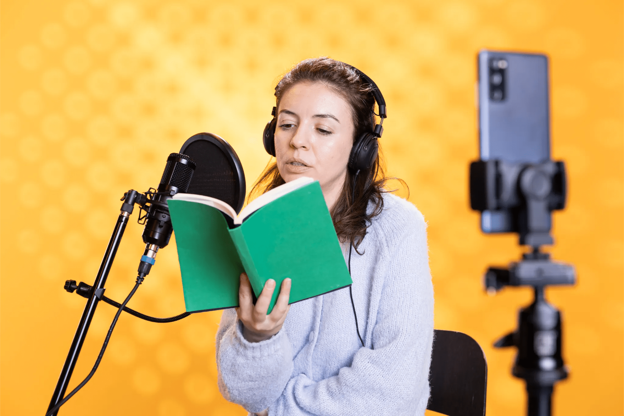 Voice-over artist reading into a microphone.