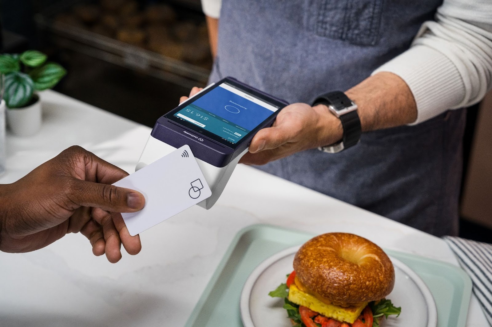 A Cashier Processes a Payment with GoDaddy Tap to Pay