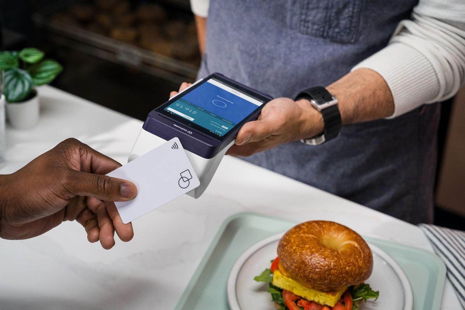 A Cashier Processes a Payment with GoDaddy Tap to Pay