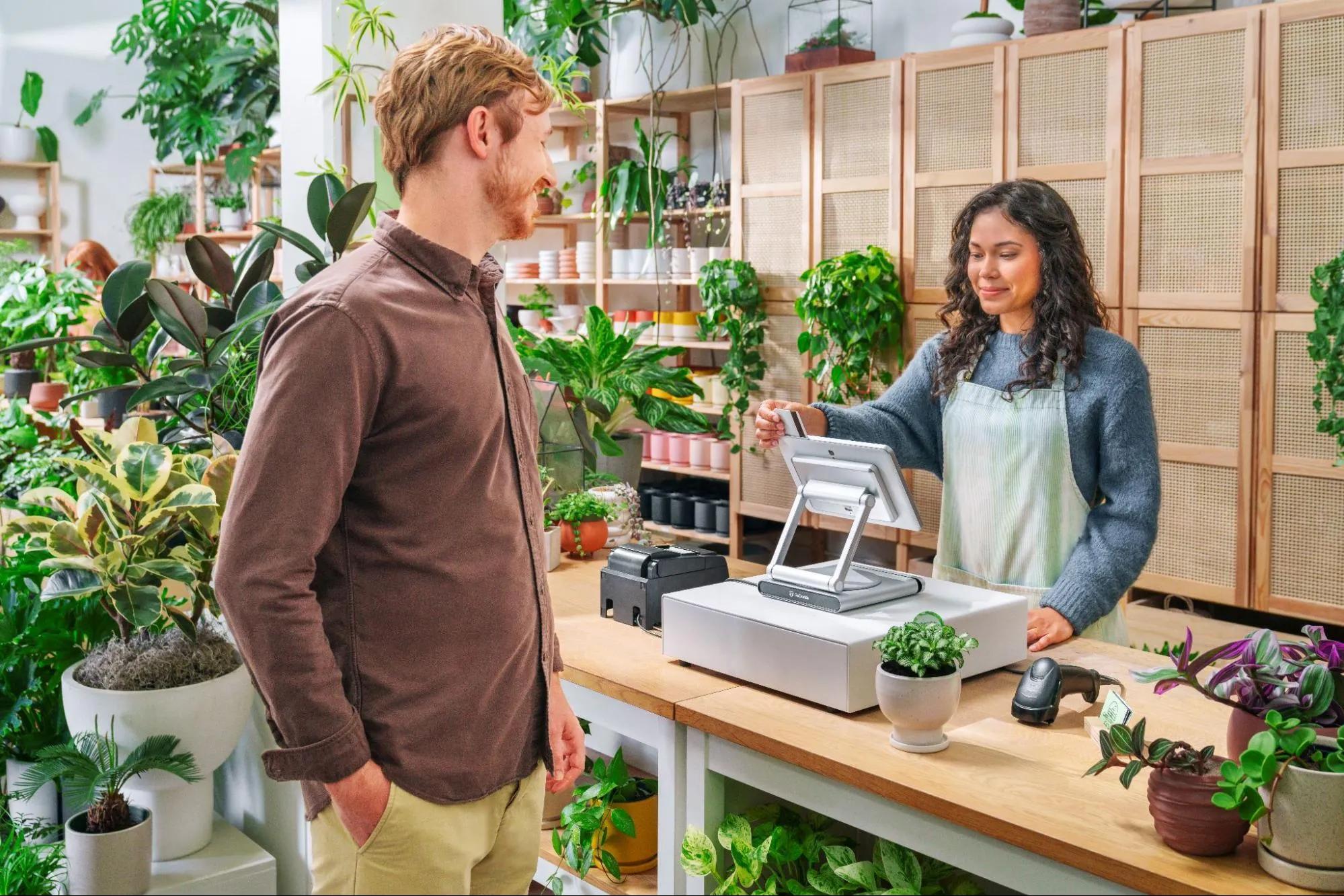 A Merchant Rings up a Customer Using a GoDaddy Smart Terminal