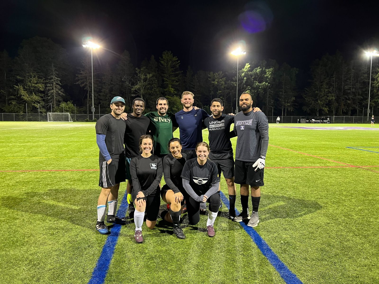 a group of people posing for a photo on a football field