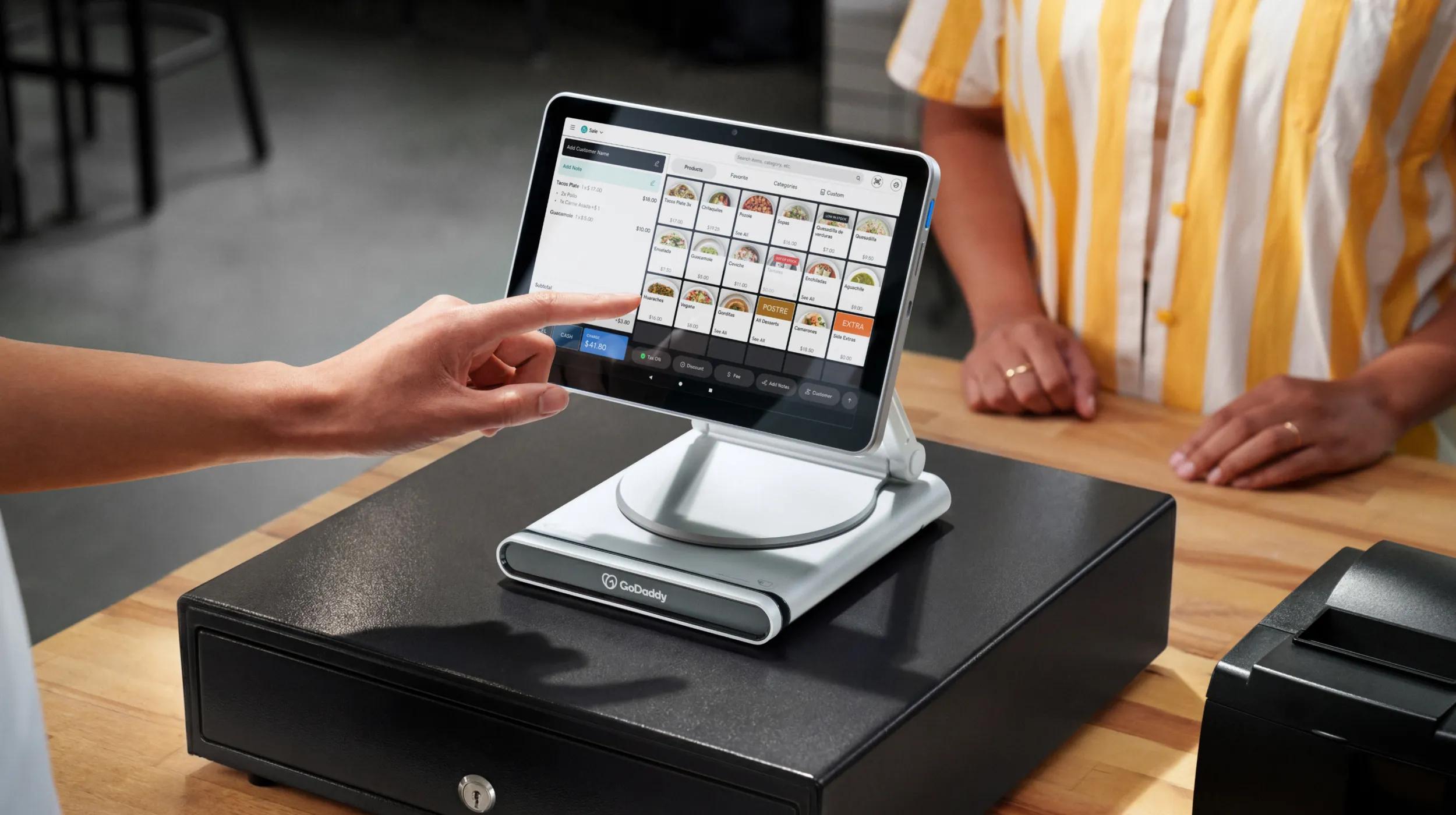 A Hand Engages a POS System