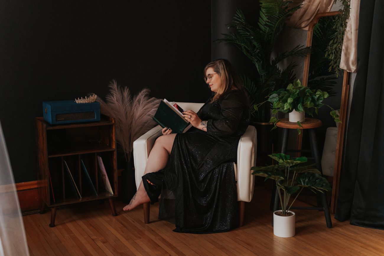 a person sitting on a chair with a laptop