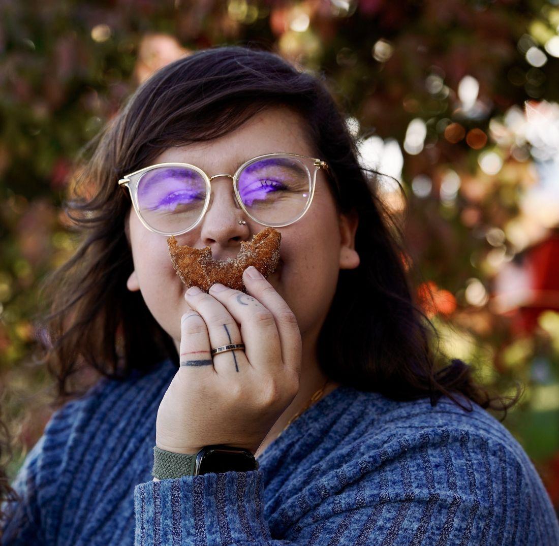 a woman eating a donut